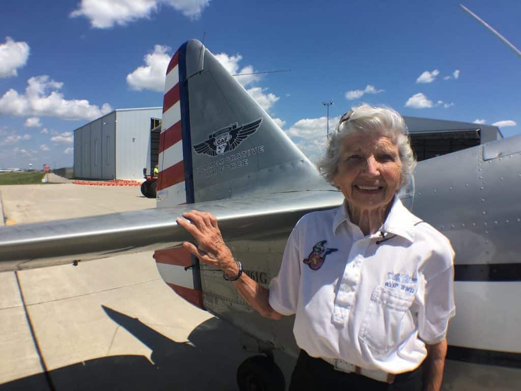 Marty Wyall standing next to the CAF's T-6 freshly repainted to represent on of the many T-6s flown by the WASP during the war. Photo by CAF MEdia