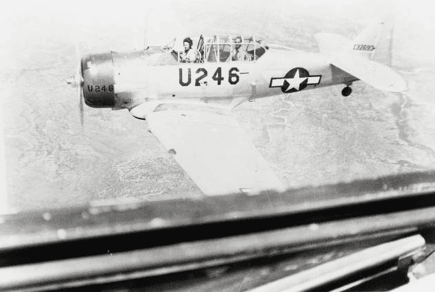 This image, taken from an AT-6 in flight shows the colored cowling and U fuselage code during the later portion of the WASP training program. (Image courtesy of The WASP Archive, The TWU Libraries’ Woman’s Collection, Texas Woman’s University, Denton, Texas