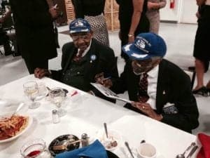 The Tuskegee Airmen signing autographs.